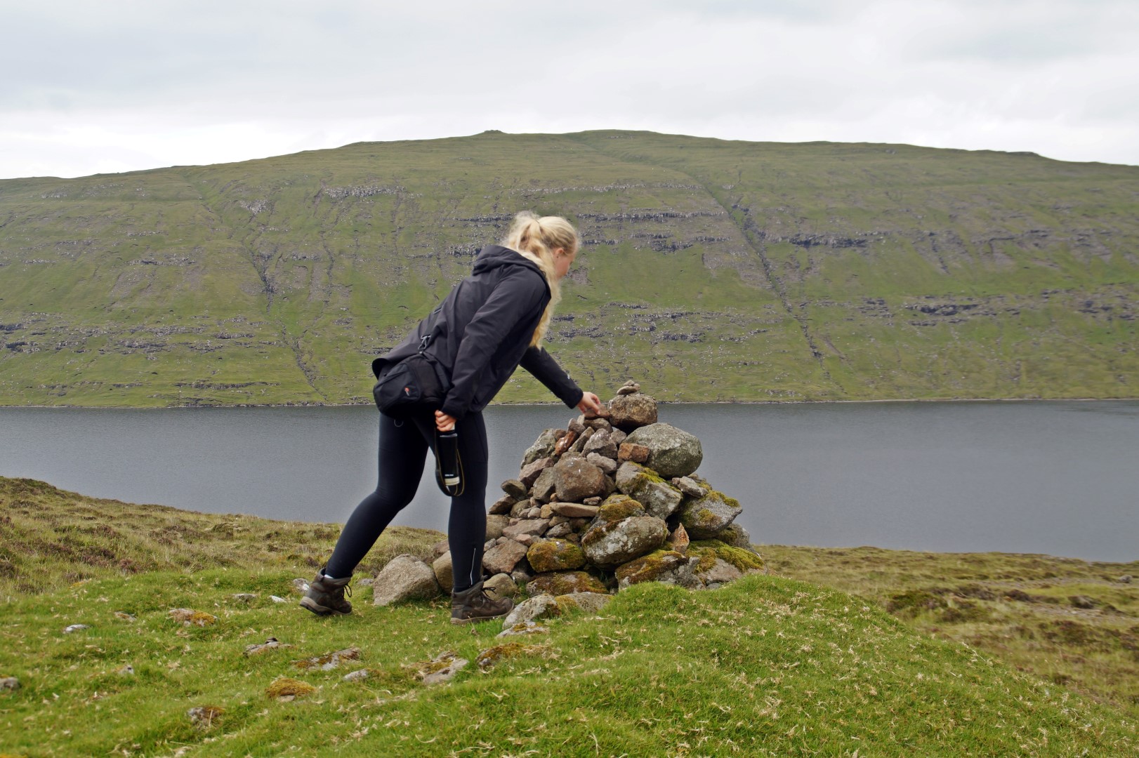 Katrine following Faroese tradition by putting a stone on the cairn as we walk by